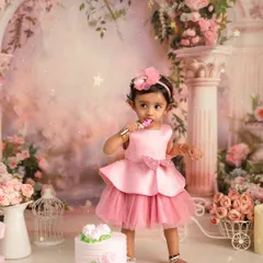 The best part of a first birthday is the cake. This adorable shot captures the birthday girl enjoying her first taste of cake during her princess themed cake smash session.