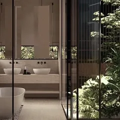 We design bathrooms as private sanctuaries that connect with nature. This space from our Moira Homes project features a freestanding tub and a glass wall that opens to a lush, private internal courtyard, transforming a daily routine into a serene, tropical experience.