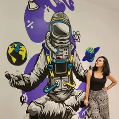 Here I am with the final astronaut mural for a teaching institute in Mumbai. The goal was to make the space more inspiring for students, and this 8x7 feet cosmic design, complete with planets and science symbols, did just that.