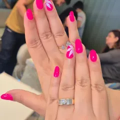 Simple elegance is always in demand. We will teach you the fine brush control needed for delicate floral nail art, like this clean design on a vibrant pink base, ensuring your work is always polished and professional.