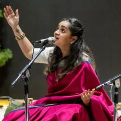 In a traditional Carnatic concert setting, I feel deeply connected to my roots. Dressed in a saree, seated on stage, I share the classical music that was my first language, a pure and soulful experience with my audience.