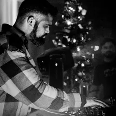A quiet moment of focus during a set around Christmas time. The festive lights in the background add a nice touch.