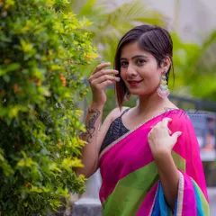 The vibrant, color-blocked saree was the star of this shoot. We used a simple, natural background to let the bold colors and the model's confident personality truly shine.