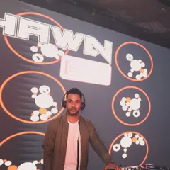 It's not just about playing music; it's about putting on a show. Here I am in my element, with custom VJ graphics lighting up the stage, making sure the visual energy matches the audio.