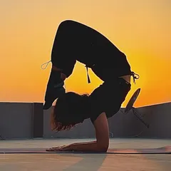 There's nothing like practicing outdoors as the sun sets. This scorpion pose on my rooftop is a testament to what consistent practice can achieve. The open sky and quiet focus make moments like these incredibly special.