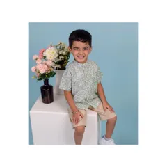 This young man’s bright smile made this studio session an absolute delight. We used a clean, simple backdrop with a pop of color from the flowers to keep the focus on his happy and charming personality.