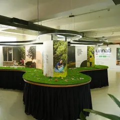 The setup of our Farm Expo at the Jayanagar HQ, with displays and a turf-covered table.