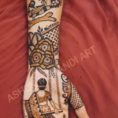 This Teej special design tells a story on the hand. It features a woman on a swing, birds, and floral patterns, capturing the traditional essence of the festival in a beautiful narrative style.