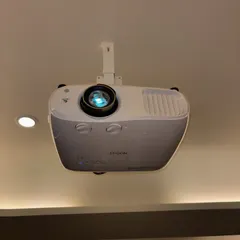 A close-up of a ceiling-mounted Epson projector in a society clubhouse. This professional installation keeps the equipment secure and out of the way, providing a clean look for the room.