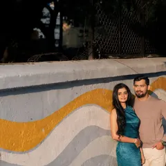 Using the strong lines and colors of street art as our backdrop, this shot captures a quiet, confident moment between the couple, with the late afternoon sun adding a touch of warmth.