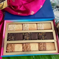 This elegant Diwali gift box is filled with my assorted shortbread cookies. The box includes three delicious flavors: lemon-drizzled, chocolate-dipped, and almond-topped, offering a buttery, melt-in-your-mouth experience.