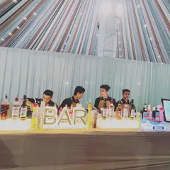Our team of professional bartenders working together to manage a busy bar at a large wedding. We ensure quick and friendly service so your guests spend less time waiting and more time celebrating.
