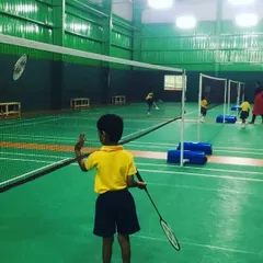 Learning the basics of the game. Here, young players practice hitting the shuttlecock over our portable mini-nets, a perfect setup for teaching foundational skills in our kids' badminton classes.