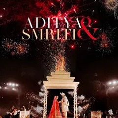 A wedding under the stars, with fireworks painting the night sky. This aerial shot captures the sheer scale and magnificence of a royal celebration at the ITC Grand Bharat, with the couple at the heart of it all.