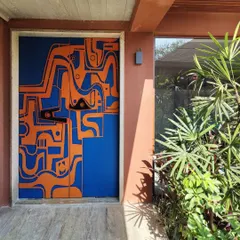 The full view of the artistic entryway, where the door becomes the focal point of the home's facade. The design was conceived to be a piece of art you interact with daily.