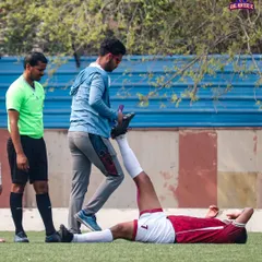 A player receiving stretching assistance from our support staff to prevent injuries.