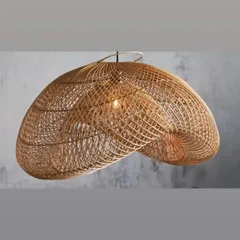 This organically shaped, handwoven rattan pendant light showcases a complex, grid-like weave. The light filters through the gaps to create a soft, diffused glow, ideal for creating a relaxed atmosphere in a lounge or bedroom.