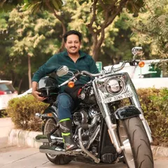 A tighter crop of the rider and his Harley, focusing on his relaxed and confident posture. This kind of portrait captures the personality of the rider as much as the bike itself.