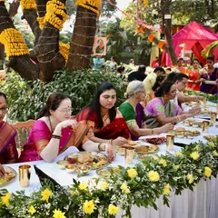 Guests enjoying the authentic Maharashtrian feast during a Pangat. The joy of sharing good food with good company is what makes these events so special.