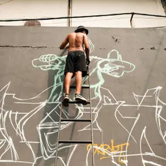 The process of going big. Up on a ladder, sketching out the initial lines for the mural. Every big piece starts with a simple outline before the colors and details come in.