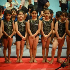 Lined up and ready to perform. This image captures the discipline and focus our gymnasts bring to every competition.