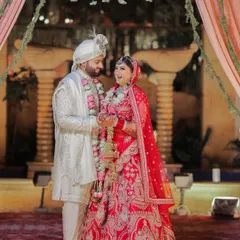A joyful moment between the bride and groom during their wedding ceremony. Their laughter and loving gaze show the happiness and comfort they find in each other, even amidst the formalities.