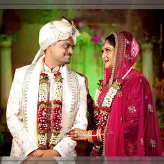 A classic wedding portrait of the couple after the varmala ceremony, looking at each other with love.