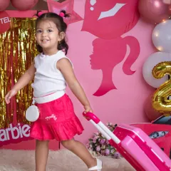 "Let's go shopping!" This little fashionista is living her Barbie dream, complete with a pink suitcase and a stylish car.