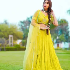 This vibrant lime-green lehenga set is a piece from my Indo-Western fusion collection. I designed it with a finely pleated skirt for beautiful movement and paired it with a hand-embroidered bustier. It’s a fresh, modern take on traditional festive wear, perfect for a mehendi or sangeet.