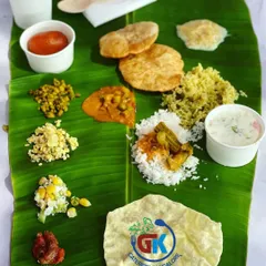 A classic festive meal served on a baale ele. This spread includes poori, chitranna, sambar rice, kosambari, pickle, and a gulab jamun for a sweet finish.