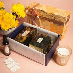 An open view of one of our curated gift sets, showcasing how we carefully arrange each item. This yellow-themed hamper includes candles and room sprays, presented with tissue paper for a premium unboxing.