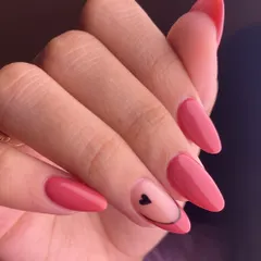 A touch of love. This dusty rose manicure is accented with a minimalist smiley face design where the eye is a tiny black heart. It's a cute and subtle way to add personality to your nails.