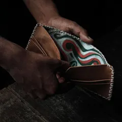 The beauty of handmade leathercraft. This wallet, with its intricate stitching and custom-printed interior, is an example of what you can learn to create. Our workshops guide you through the entire process, from cutting the leather to the final stitch.