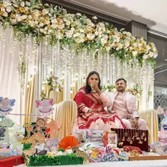 A beautiful baby shower for an expecting couple. The stage is set with gorgeous floral decor, and the parents-to-be are glowing.