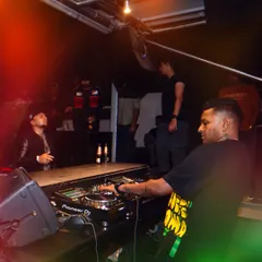 A candid moment behind the decks at Kitty Ko. I love the energy of a packed rooftop, mixing tracks as the city lights up.