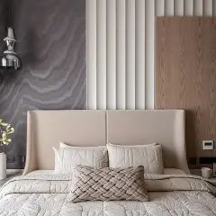 Texture is paramount in creating a sensory experience. In this tranquil bedroom, I layered a tactile, patterned wallpaper with fluted wall panels and soft, quilted bedding to craft a sanctuary of inherent stillness and calm.