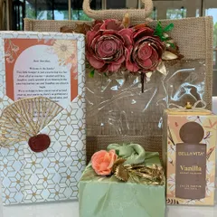 "Welcome to the family!" This warm and inviting hamper is the perfect way for cousins to welcome a groom-to-be. It features a jute bag, a personalized letter, perfume, and other thoughtful gifts.