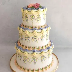 I just love the classic beauty of English piping. This three-tiered wedding cake was a recent creation, featuring delicate buttercream swags and hand-piped floral details. It’s a timeless technique that I teach in my advanced workshops.