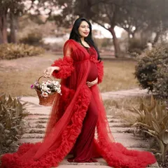 This flowing red tulle robe adds a layer of glamour and drama to any maternity shoot. It can be worn over another gown or on its own for a bold and beautiful look.