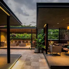 The Chhabria's Terrace project in Bengaluru, showcasing a modern, open-air lounge concept. The design uses a mix of covered and open spaces, creating different zones for relaxation and socializing.