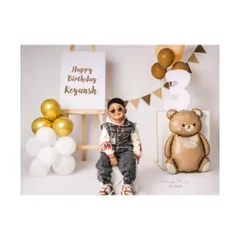 Three, teddy, and totally adorable! This little man is rocking his third birthday photoshoot with a cool outfit and a stylish, modern setup.