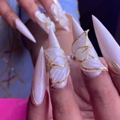 This is what I call wearable art. These long stiletto nails feature delicate, hand-sculpted 3D butterflies with gold leaf accents, perfect for a wedding or any special occasion where you want to make a statement.