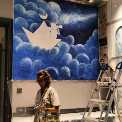 Me standing with the work-in-progress of the stargazer mural. It's a joy to bring such imaginative concepts from a sketch to a large-scale piece of art.