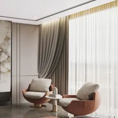 A cozy seating nook within a modern bedroom, featuring two comfortable tan swivel chairs. The room's design includes a marble media unit with an integrated electric fireplace below, adding warmth and ambiance.