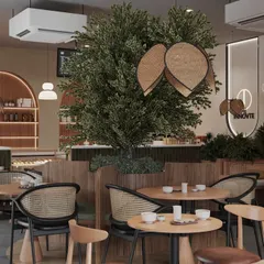 This view shows the different zones we created within the open layout. The central tree seating, the counter area, and the window-side tables all feel distinct yet connected, offering customers a choice of experience.