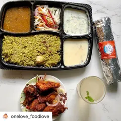 This is a perfect work-from-home lunch. A customer is enjoying our Thuppangadi Chicken Biryani combo, which includes Bangalore-style chicken kebab and a Chicken Ghee Roast roll on the side.