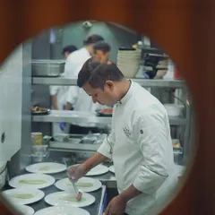 A peek into the kitchen during a busy service. Our chefs work with precision and focus to ensure every plate that leaves the kitchen is perfect.