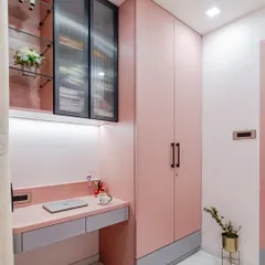 This view showcases how I integrate multiple functions into a single, cohesive unit. The dusty pink wardrobe, sleek study desk, and overhead storage work together to create a streamlined and organized space that feels both spacious and personal.