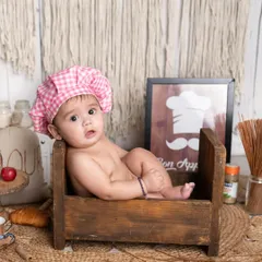 Our little chef is ready to take your order! I have so much fun with creative baby photo themes, and this kitchen setup with a tiny chef's hat is one of my absolute favorites.