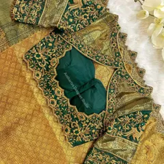 A majestic bridal blouse in bottle green and gold. The sleeves and back are heavily embroidered with traditional motifs, making it a truly royal piece.